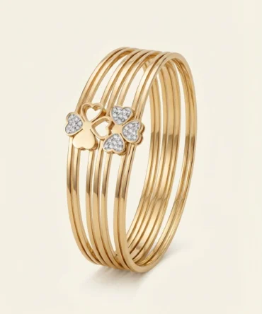 Gold multi-layer bangle with diamond heart design on hand