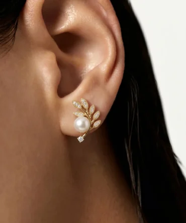 Gold plated olive branch stud earrings with CZ pavé leaves, centred pearl and solitaire CZ tip, studio product pair shot