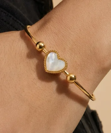 Gold plated bracelet with heart centre and pearl-like detail on sleek band for women