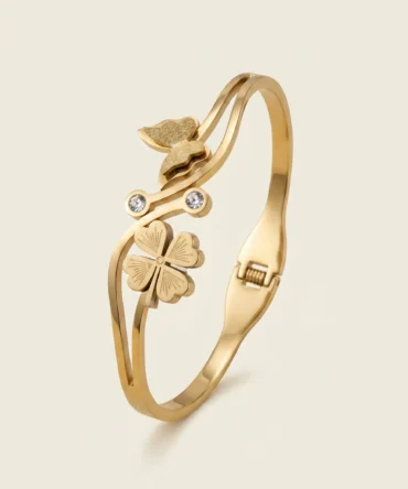 Gold plated bracelet with floral charm and butterfly detail on structured band for women