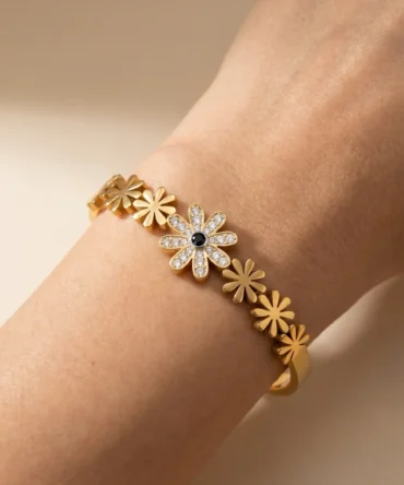Gold plated floral bracelet with diamond finish crystals and central flower design for women