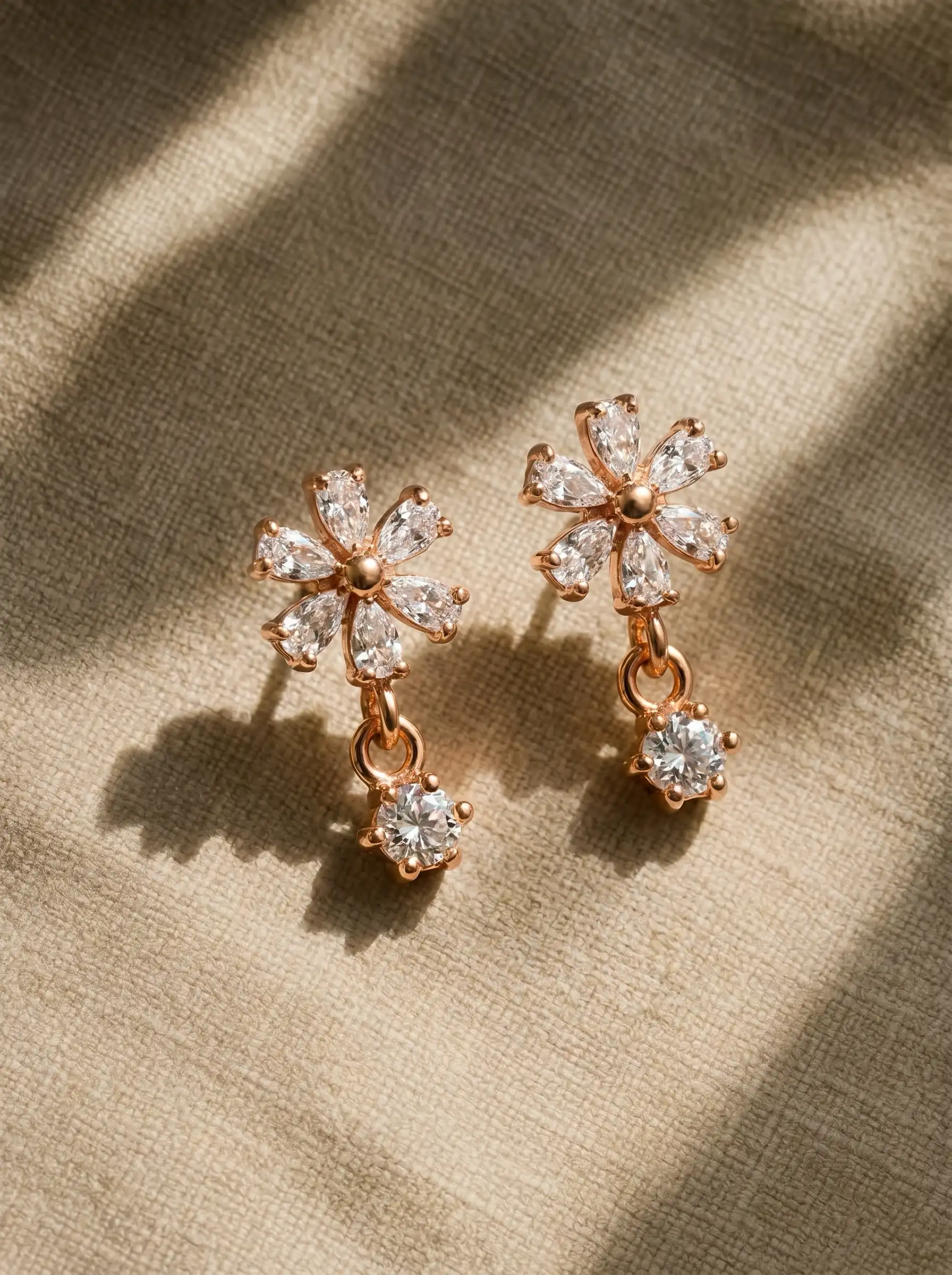 Rose gold plated floral earrings with diamond finish crystals and small drop charm for women