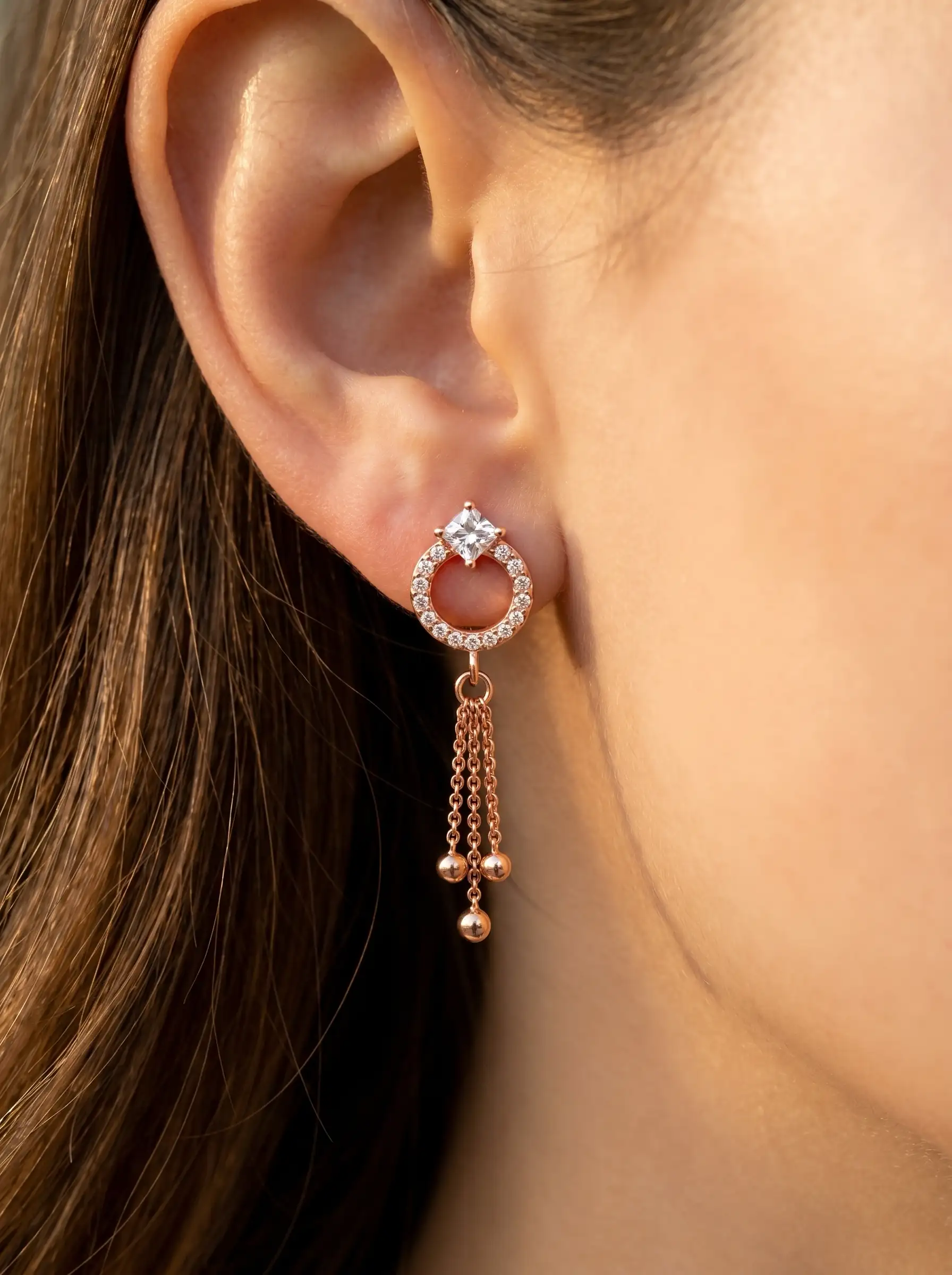 Rose gold plated drop earrings with diamond finish crystals and tassel chain detail for women