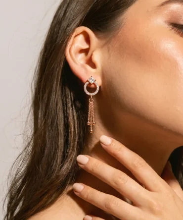 Rose gold plated drop earrings with diamond finish crystals and tassel chain detail for women