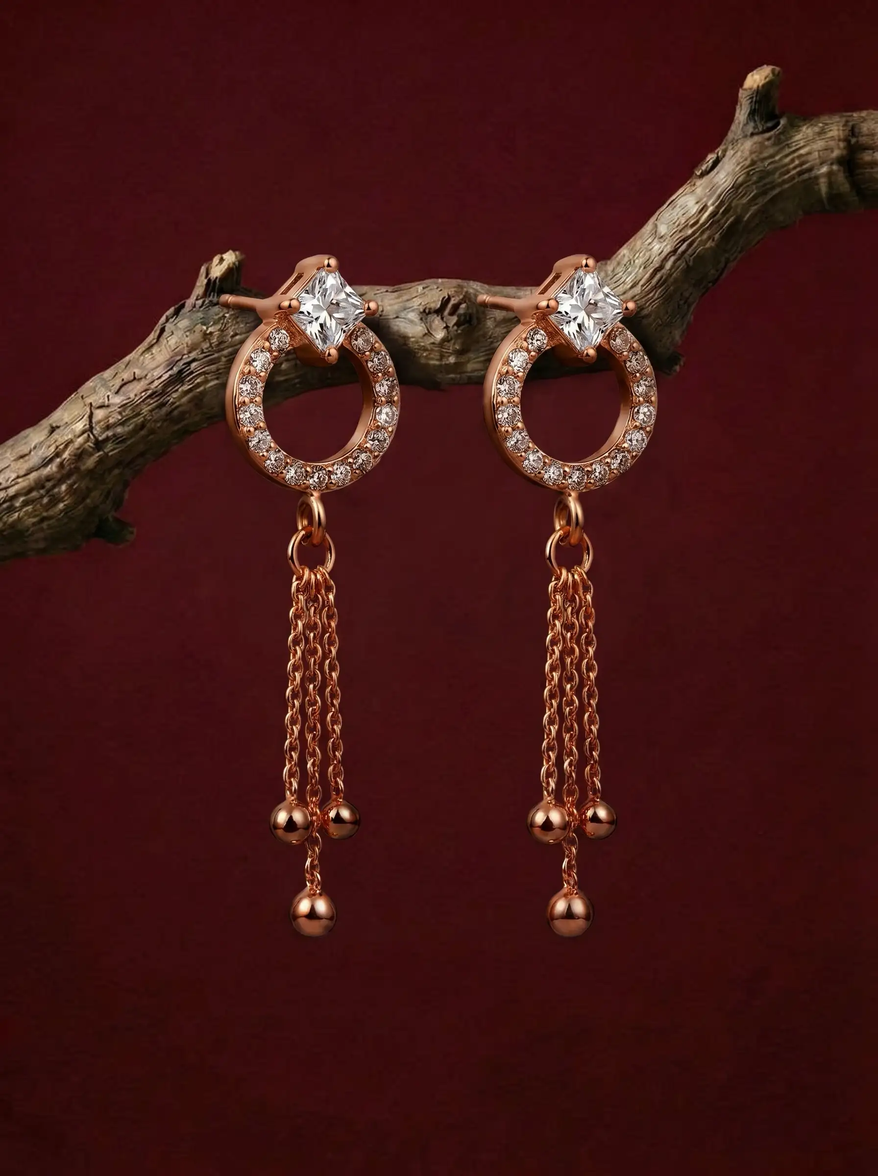 Rose gold plated drop earrings with diamond finish crystals and tassel chain detail for women
