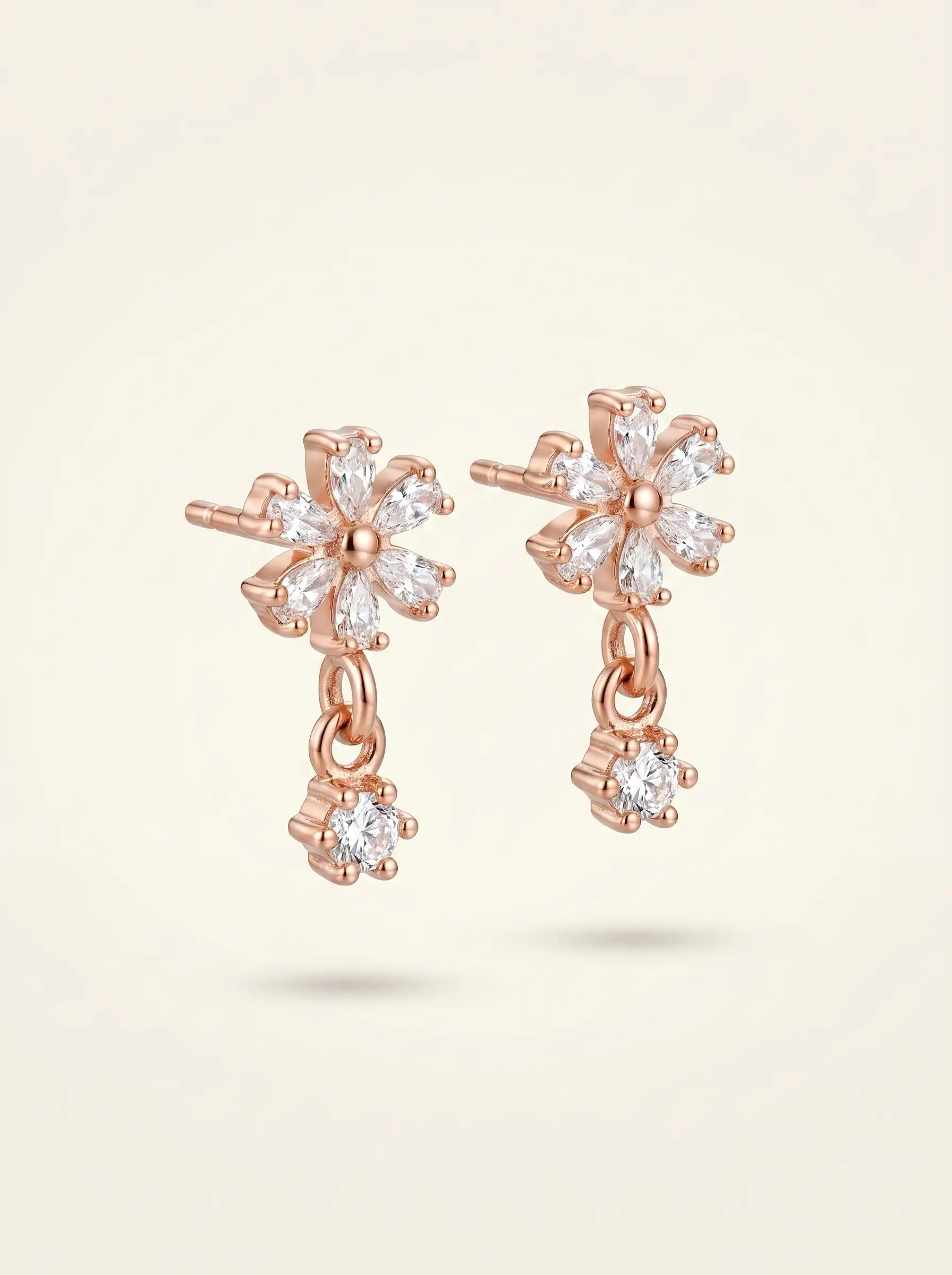 Rose gold plated floral earrings with diamond finish crystals and small drop charm for women