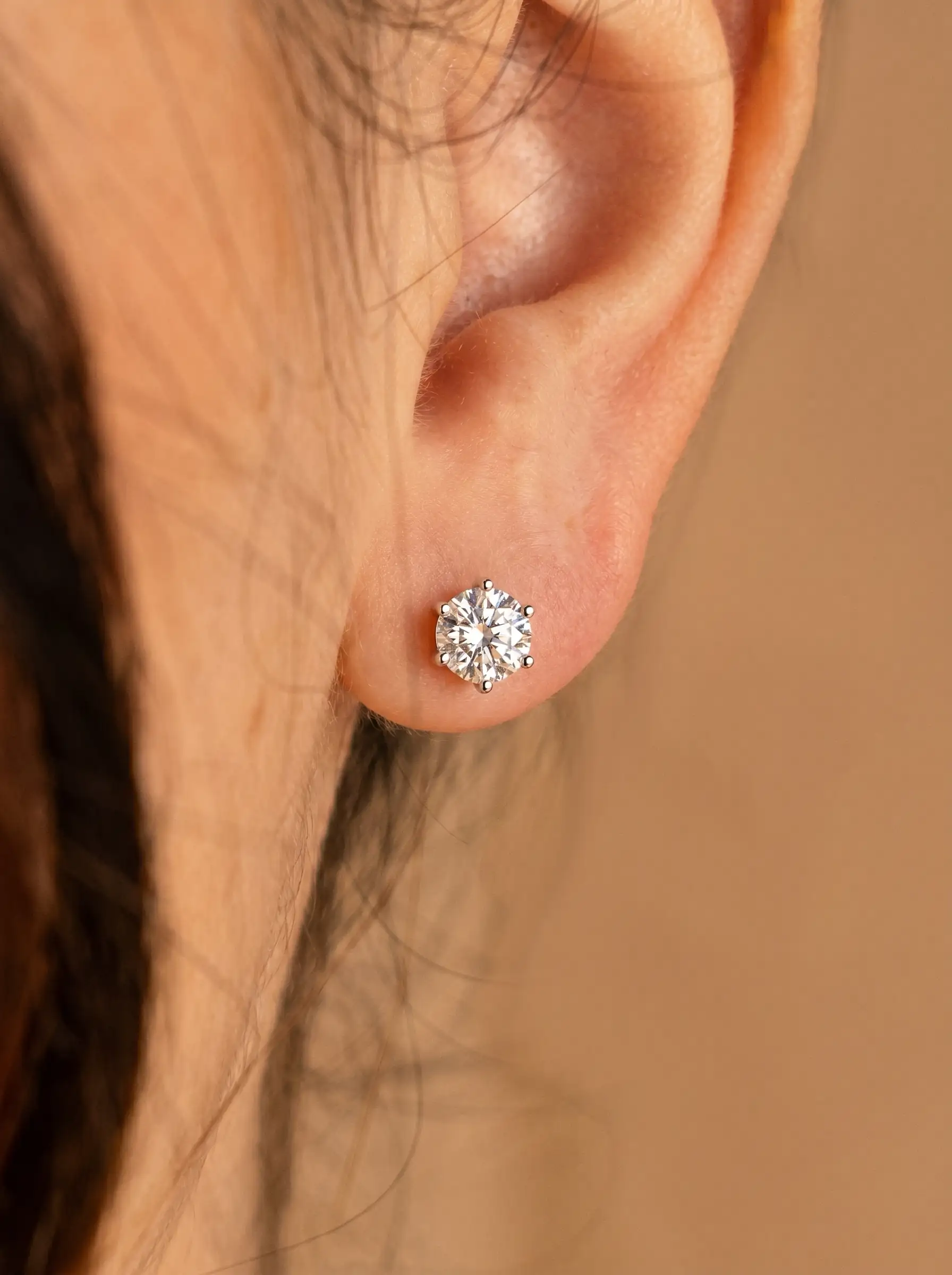 Silver tone solitaire stud earrings with round crystal and multi prong setting for women