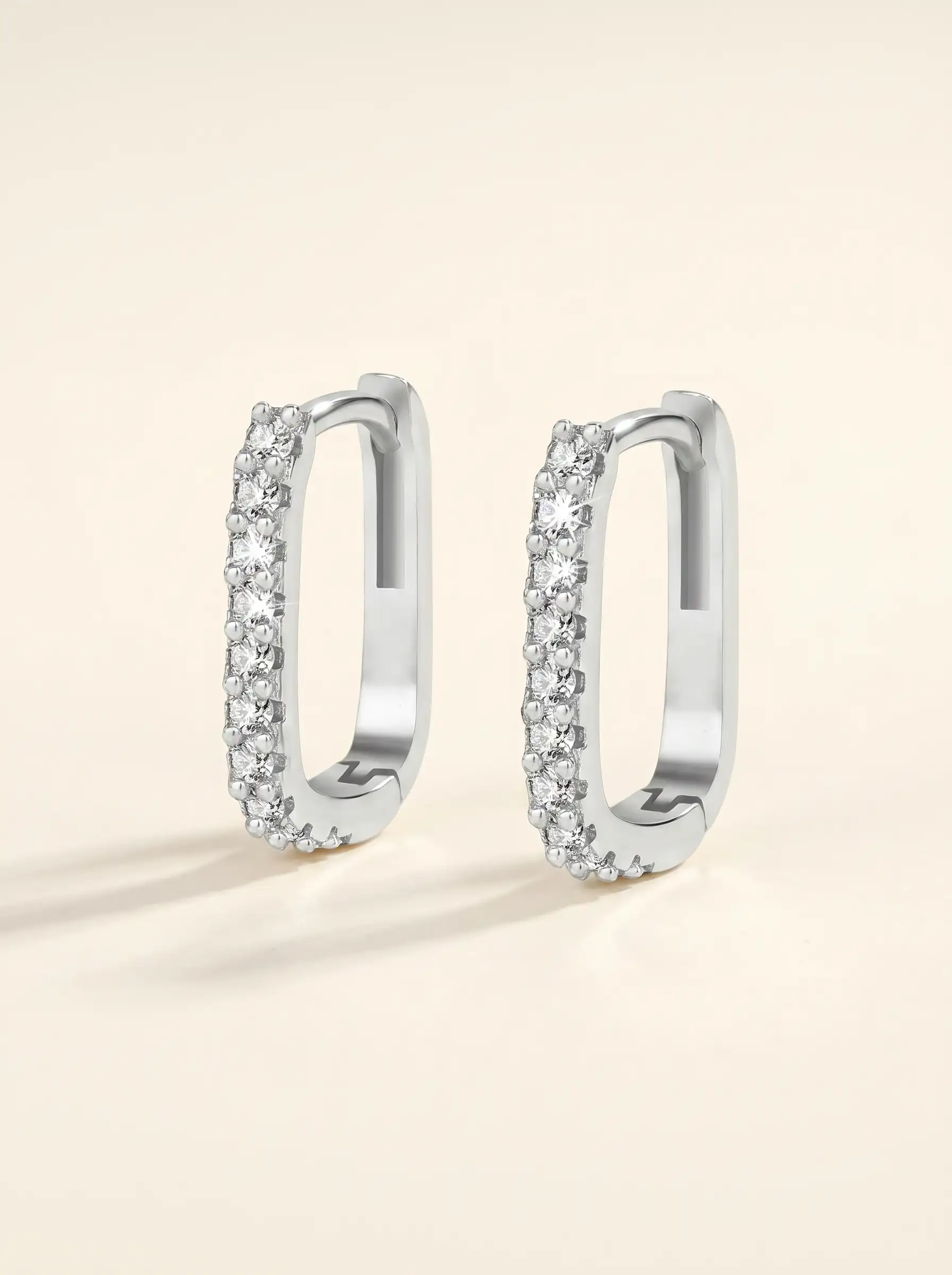 Silver tone geometric hoop earrings with crystal studded front design for women