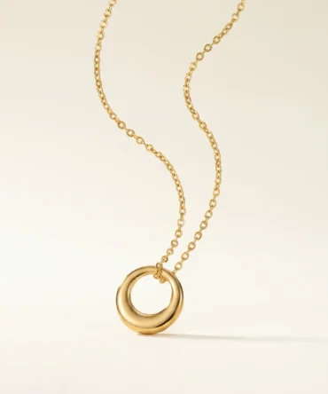 Gold tone circular pendant necklace with smooth polished geometric ring design for women