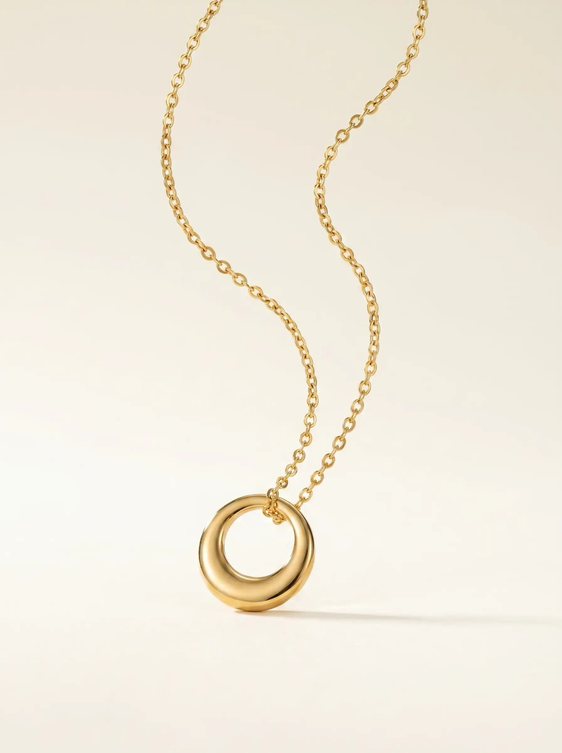 Gold tone circular pendant necklace with smooth polished geometric ring design for women