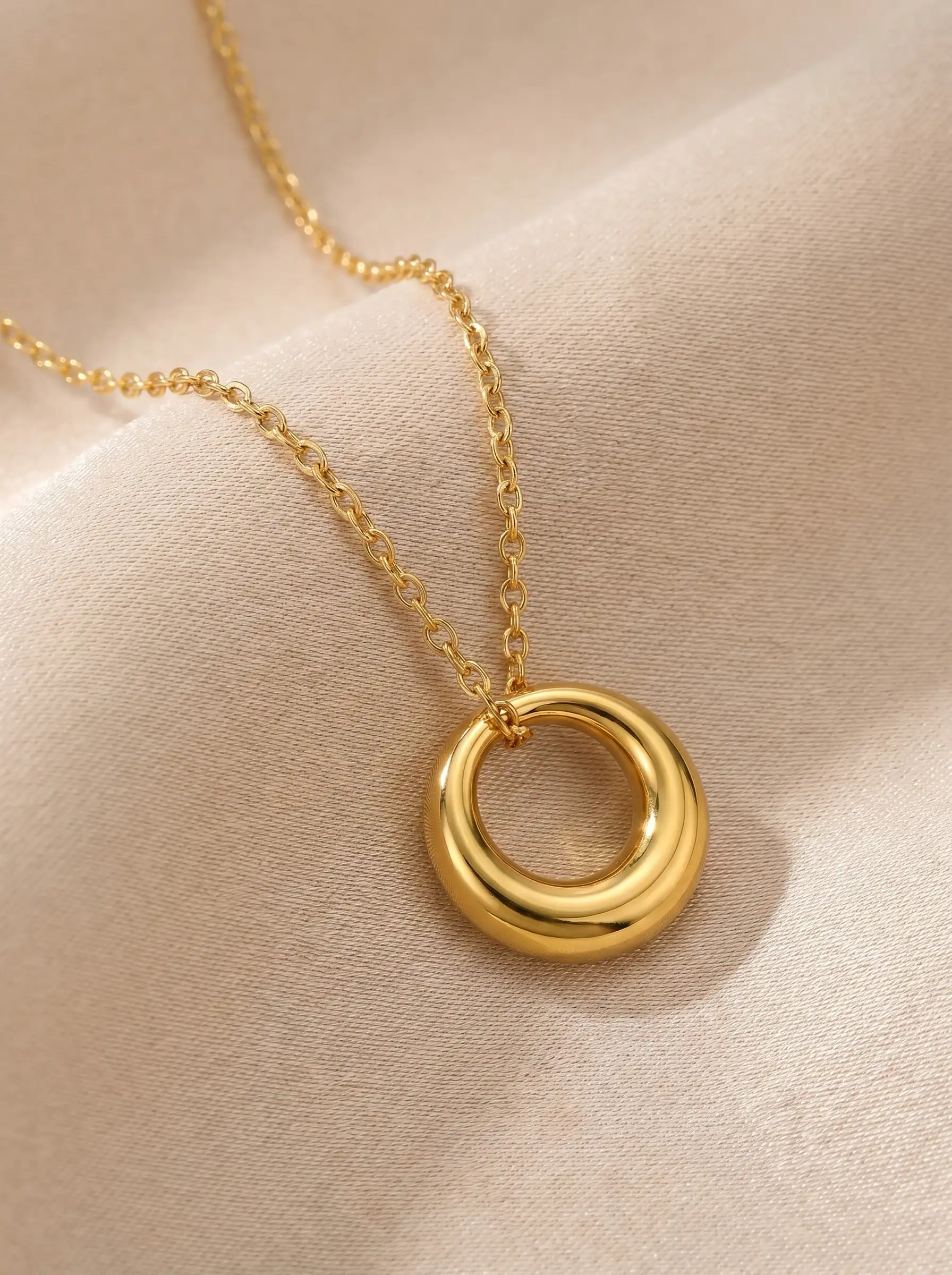 Gold tone circular pendant necklace with smooth polished geometric ring design for women