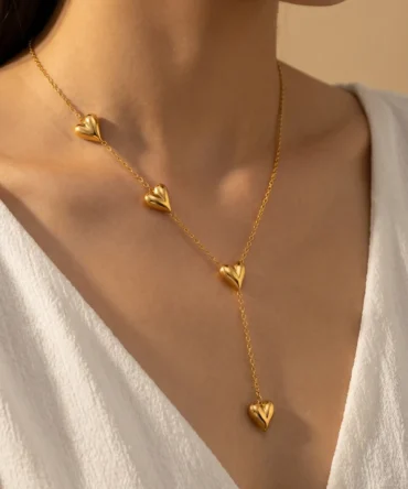 Gold tone long necklace with multiple heart pendants and drop chain design for women