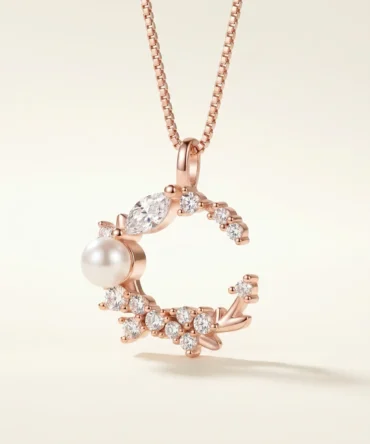 Rose gold tone moon shaped pendant with crystal cluster and pearl detail for women