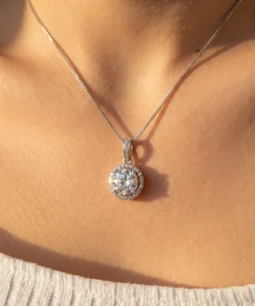 Silver tone circular solitaire pendant with crystal halo setting on chain for women
