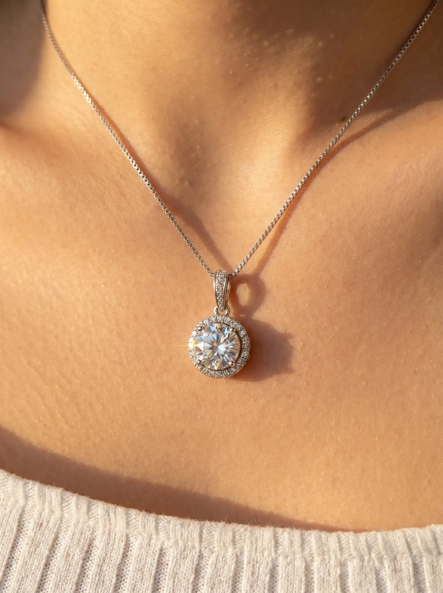 Silver tone circular solitaire pendant with crystal halo setting on chain for women