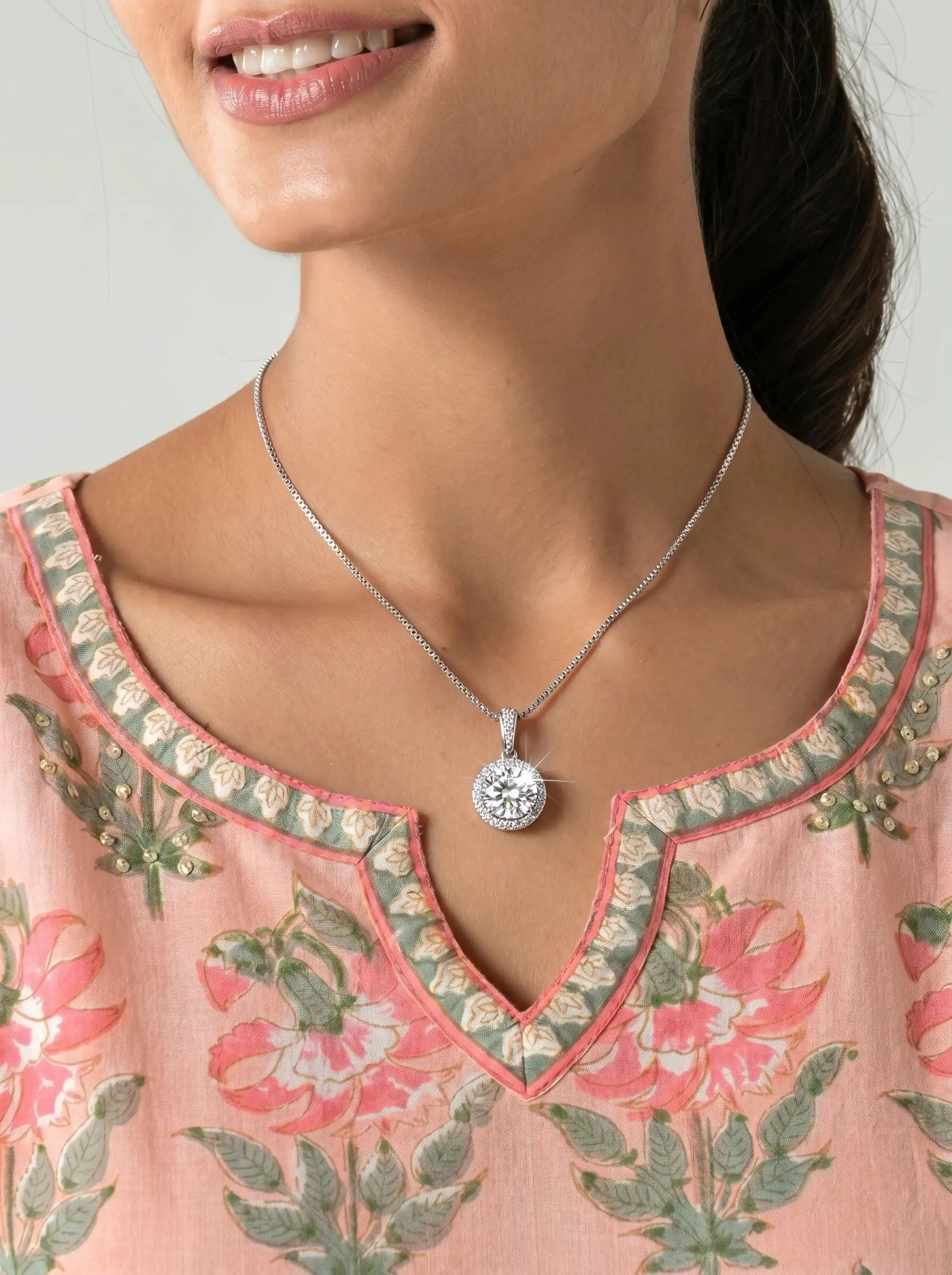 Silver tone circular solitaire pendant with crystal halo setting on chain for women