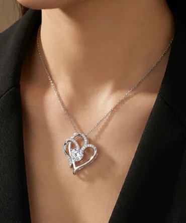 Silver tone heart shaped pendant with central crystal and studded detailing on chain for women