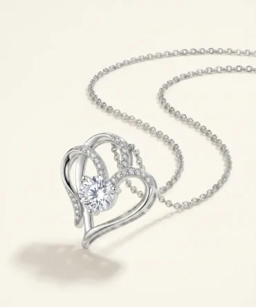 Silver tone heart shaped pendant with central crystal and studded detailing on chain for women