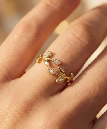 Gold plated adjustable leaf inspired finger ring with American diamond accents for women